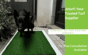 Black dog about to urinate on artificial turf placed on a patio